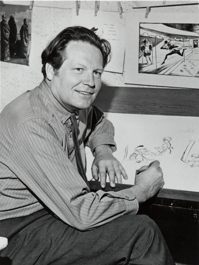 Image of Don Freeman, c.1954, with one of the Great Shakes images in the background.