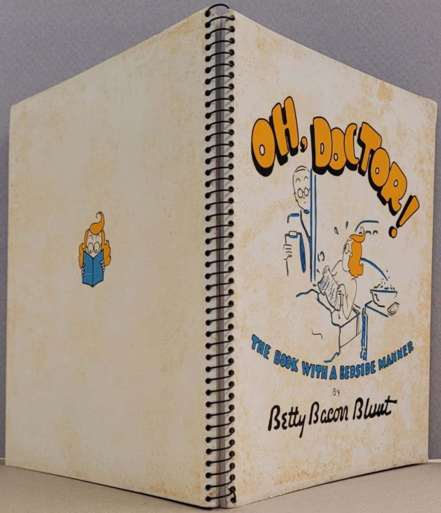 Betty Bacon Blunt's 1941 wordless novel Oh Doctor! with a wire spiral binding and its covers. 
NOTE: the splotches (foxing?) on the covers is a defect.