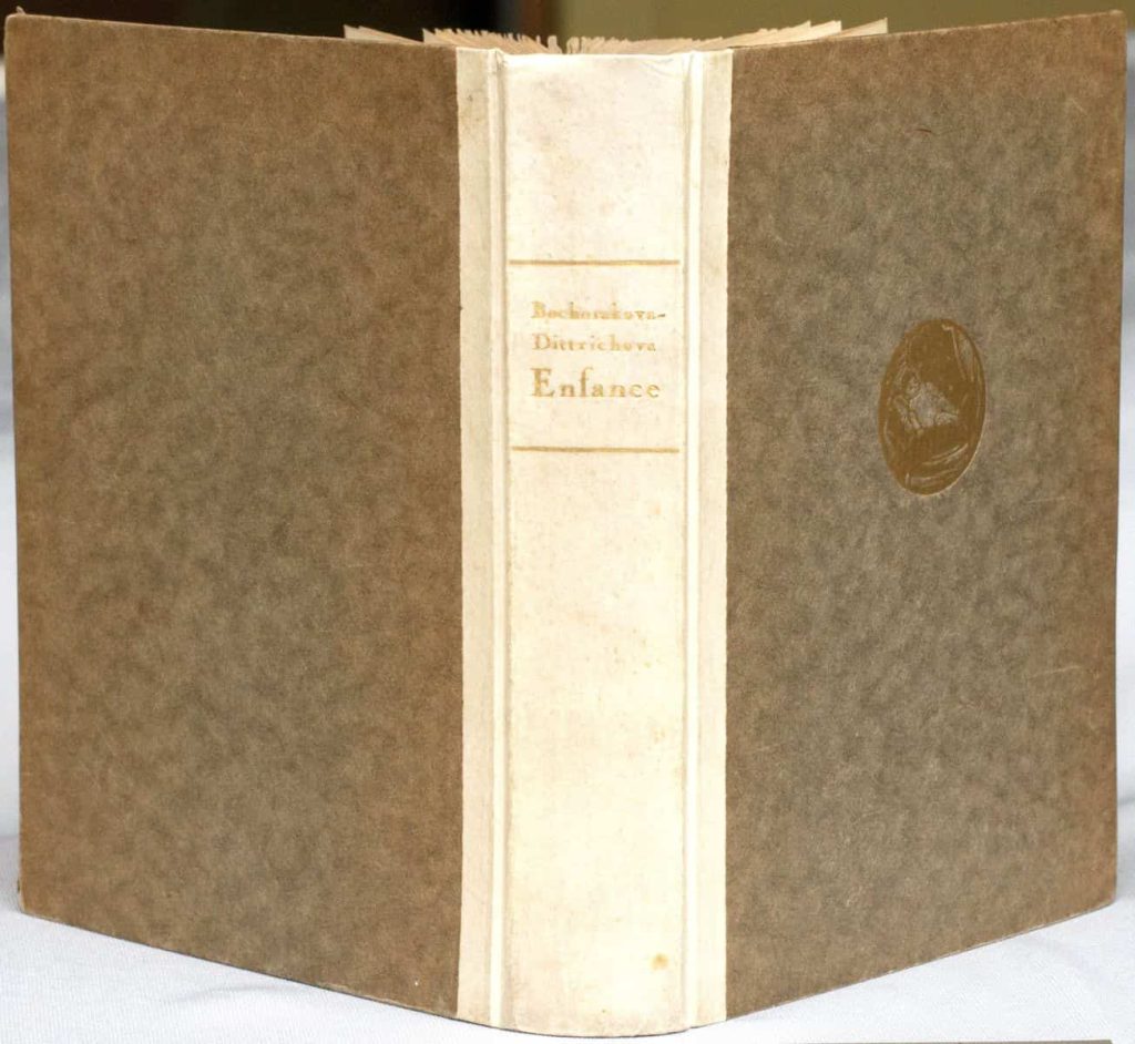 Bochorakova's Enfance (the French version of Z Mého Detství)
showing the front cover with a gold stamped medallion of a baby,
the vellum spine with gold lettering and and the back cover of the limited edition.