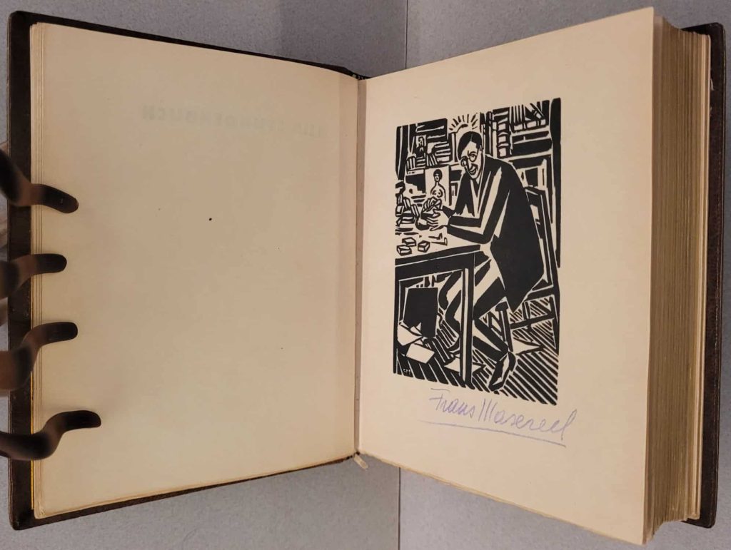 Frontis of Masereel's 1920 wordless novel, Mein Stundenbuch, signed with his typical mauve pencil.